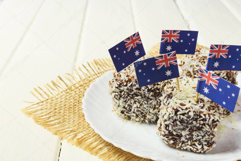 Iconic traditional Australian party food, Lamington cakes on a red, white and blue background. Australia flag.