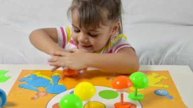 Masa oyunu ve çocukların eğlence konsepti. Küçük kız evde oynuyor. Renkli oyun.