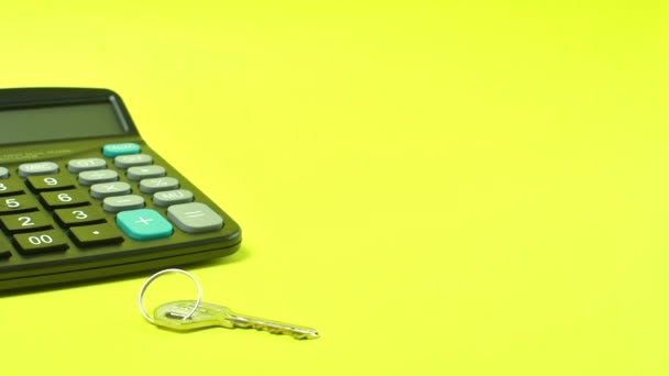Modelo rojo pequeño coche de juguete con llaves y calculadora de fondo amarillo. — Vídeos de Stock