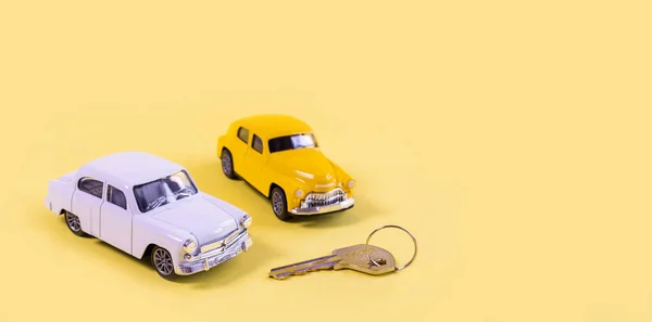 toy cars isolated on yellow background. Purchase or sell car concept. Insurance concept.