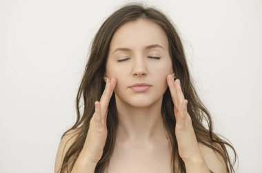 Genç, güzel bir kadın esmer yüzüne dokunuyor.