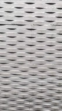 3D oyma gri bazalt duvar kiremitleri yontulmuş yatay oval kabartma ve mimari cepheler ve minimalist iç tasarımlar için doğrusal oymalı doku. Dikey görüntü geçişi.