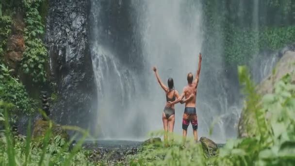 Jong reizend koppel verkennen waterval in Bali, genieten van natuur en vakantie — Stockvideo