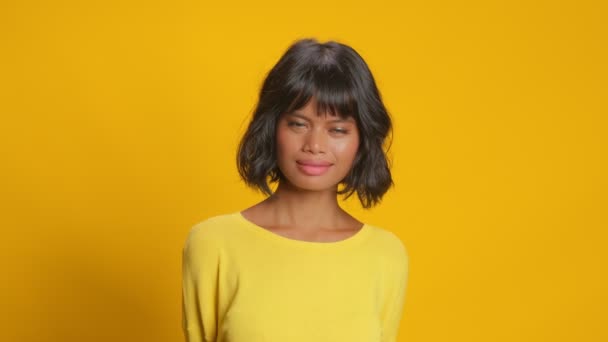 Young woman looks confidently at camera smile gently as hears something pleasant — Stock Video