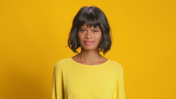 Emotive young woman surprise raises hands hear great news over yellow background — Stock Video