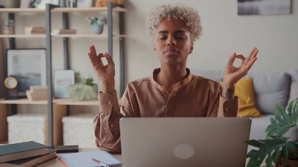 stock image Serene African woman relieving fatigue at workplace make meditation practice