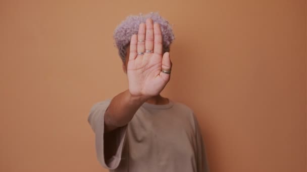 Donna africana che mostra il segno di stop con le palme su sfondo beige — Video Stock