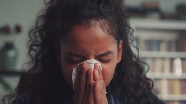 Close up ill allergic upset young Indian woman blowing running nose in tissue — Stock Video