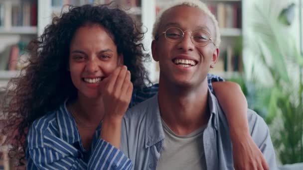 Smiling biracial couple rest on cozy sofa have fun enjoying leisure weekend — Stock Video