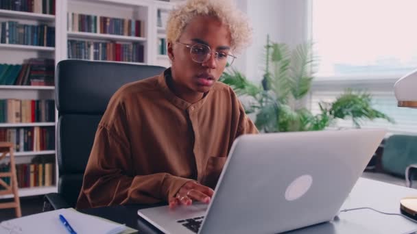 Femme africaine réfléchie regardant l'écran d'ordinateur portable, réfléchissant à la solution de problème — Video