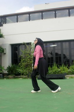 Parkta badminton oynayan Asyalı kadın