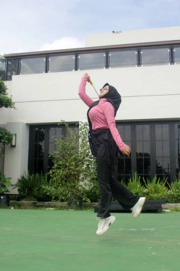 Parkta badminton oynayan Asyalı kadın