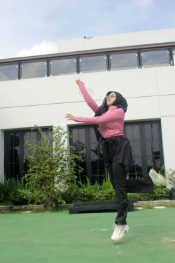 Parkta badminton oynayan Asyalı kadın