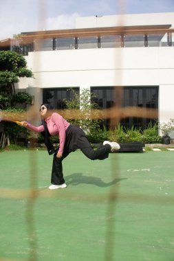 Parkta badminton oynayan Asyalı kadın