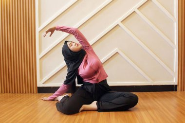 Paspasın üzerinde jimnastik yapan genç bir kadın.