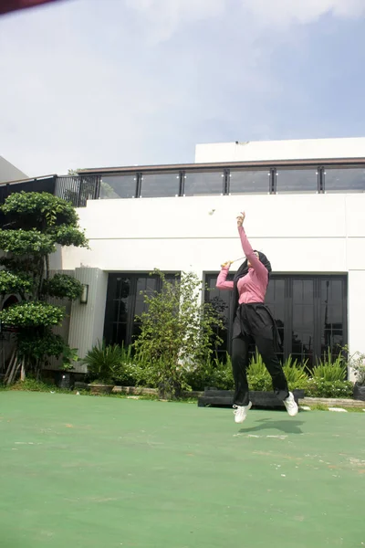 Parkta badminton yapan Asyalı kadın.