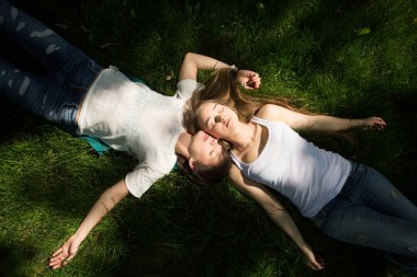iki genç kadın sevgilisi bir parkta çimlerin üzerine yaz gün dinlen