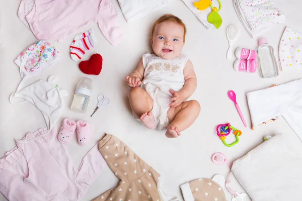 Bebé sobre fondo blanco con ropa, artículos de tocador, juguetes y accesorios para el cuidado de la salud. Lista de deseos o descripción general de compras para el embarazo y la ducha del bebé . — Foto de Stock