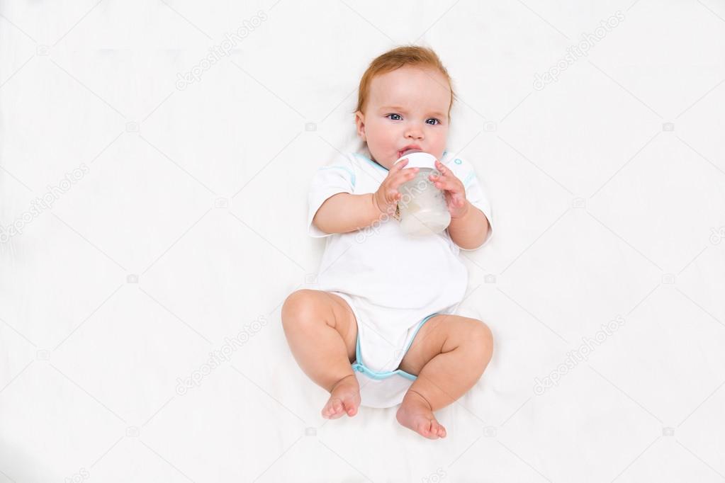 baby holding bottle