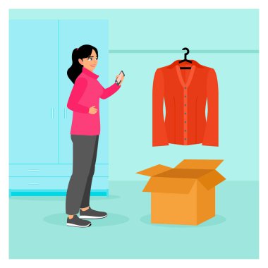 Kıyafet konsepti sat. Markette satmak için kullanılmış giysilerin fotoğraflarını çeken güzel bir kız. Bit pazarı endüstrisi, küçük işletmeler için ikinci el mağazalar..