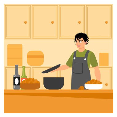 Erkek yemek konsepti. Önlük takan genç bir adam yemek yapmak için tavayla yemek pişiriyor..