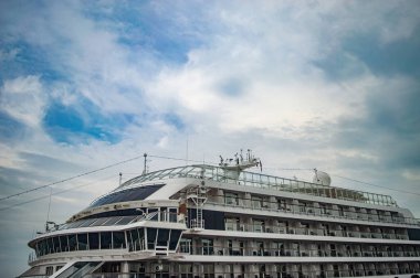 Partial exterior view of the viking orion cruise ship docked at surabaya tanjung perak port under a cloudy sky. Travel and maritime transport concept, indonesia, 14 november 2025.