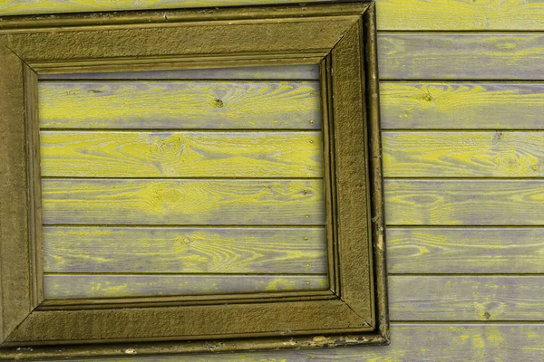 vintage yellow frame lies on wooden surface. High quality photo