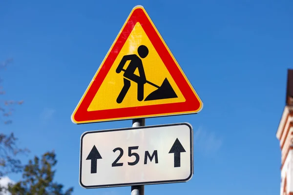 traffic sign. red triangle with a human figure with a shovel on a yellow background. construction work. High quality photo