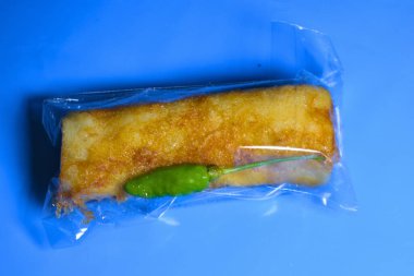 thai food, rice wrapped in plastic wrap.