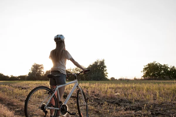 Young woman with bicycle — Stock Photo, Image