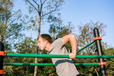 triceps DIP paralel Bar açık havada üzerinde yapan genç erkek