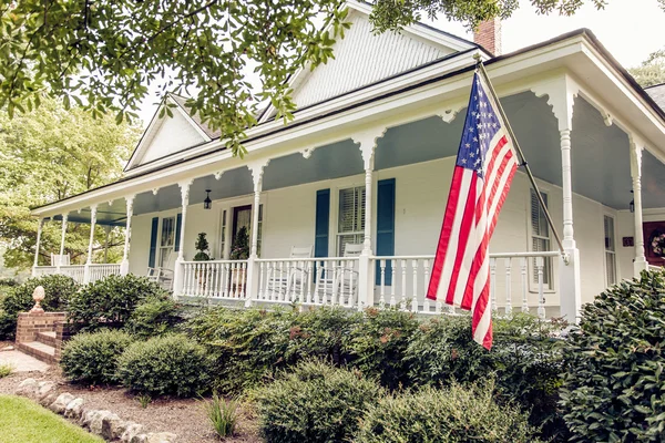 White Victorian Home with American Flag