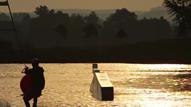 Wakeboarder saltando sobre trampolín — Vídeos de Stock