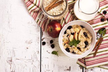 Oatmeal porridge with berries and fruits clipart
