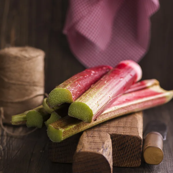 Fresh rhubarb on cutting board — Stock Photo, Image