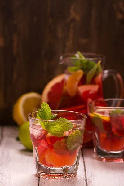 Glass of summer drink with citrus fruits — Stock Photo, Image