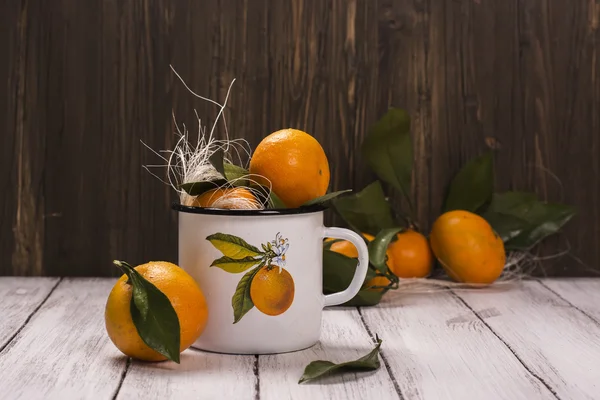 Tangerines in white enamel retro mug — Stock Photo, Image