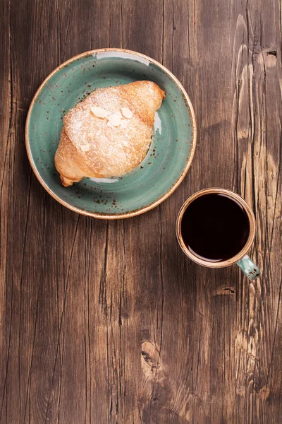 Croissant frais et tasse de café noir — Photo