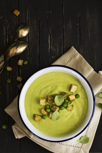 Green pea cream soup with croutons and herbs — Stock Image Green pea cream soup with croutons and herbs Stock Photo