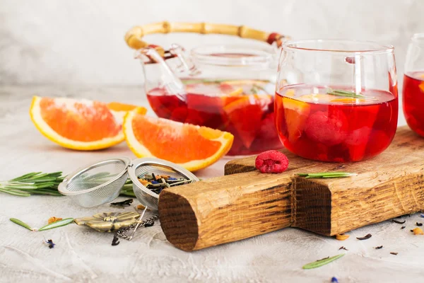 Fruit and berry tea in a glass pot — Stock Photo, Image