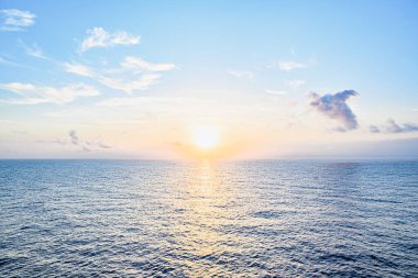 Beautiful orange sunrise sky over the sea horizon. Summer golden hour.