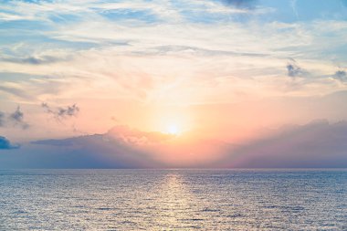 Beautiful orange sunrise sky over the sea horizon. Summer golden hour.