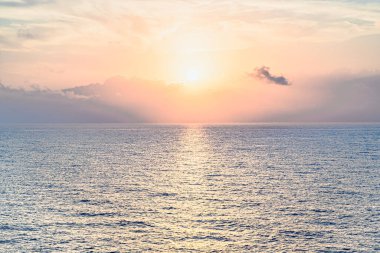Beautiful orange sunrise sky over the sea horizon. Summer golden hour.