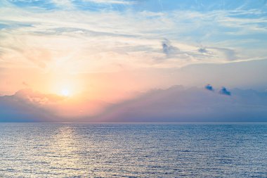 Beautiful orange sunrise sky over the sea horizon. Summer golden hour.
