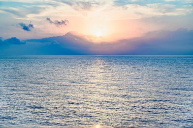 Beautiful orange sunrise sky over the sea horizon. Summer golden hour.