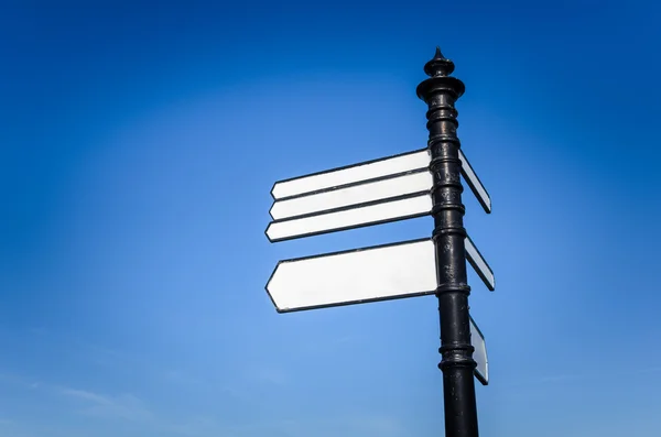 Street Signpost with four Blank Signs on a sky background. — Stock Photo, Image