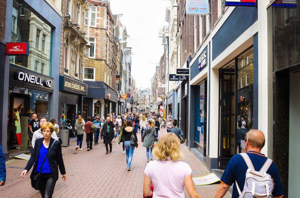 Tourists and Locals wandering around a Pedestrian Shopping Street in Amsterdam
