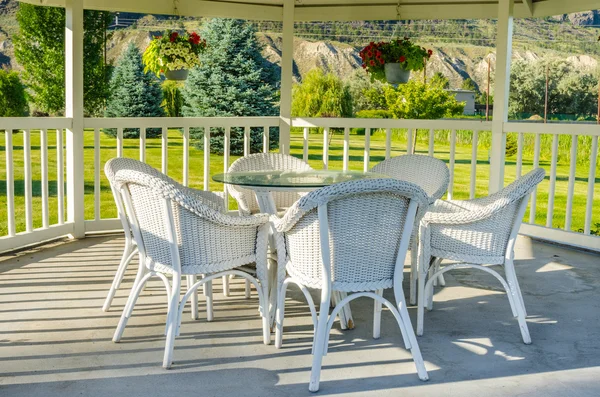 White Chairs around a Glass Table uder a Gazebo — Stock Photo, Image