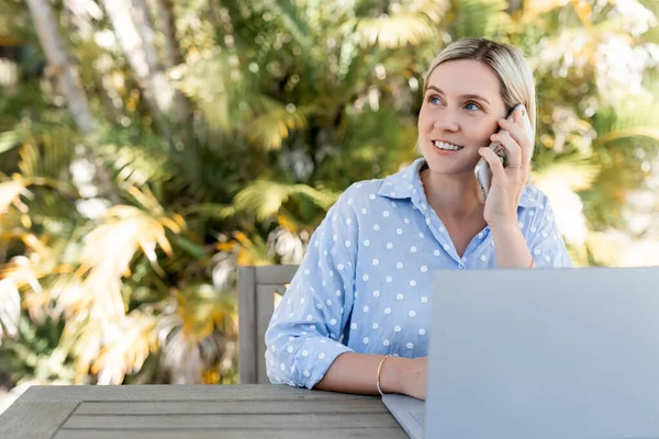 Junge Geschäftsfrau arbeitet draußen am Laptop. Stockbild