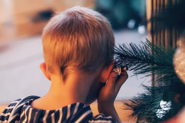 Симпатичный малыш играет с огнями на елке украшения — стоковое фото
